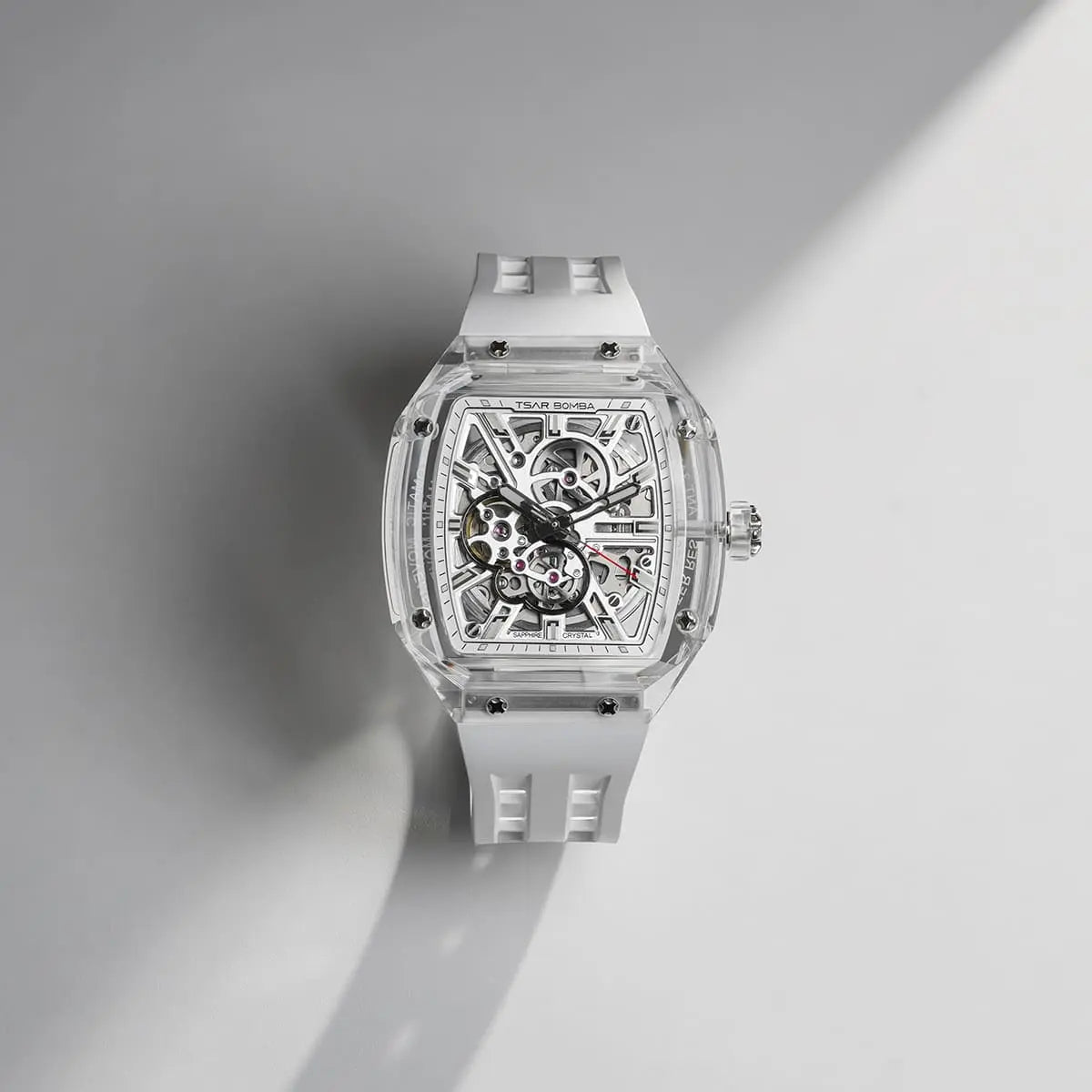 TSAR BOMBA Light Matter TB8223 Transparent Men's Watch. This watch features a TSAR BOMBA Chronite® case, allowing for quick and easy strap changes without tools. It is powered by a Japanese automatic movement with a flying tourbillon at 9 o'clock. The TB8223 includes a Grade A luminous coating, a scratch-resistant sapphire crystal, and a replaceable fluoroelastomer strap. It is water-resistant to 30 meters (3 ATM). --Accessories Display-Scene display
