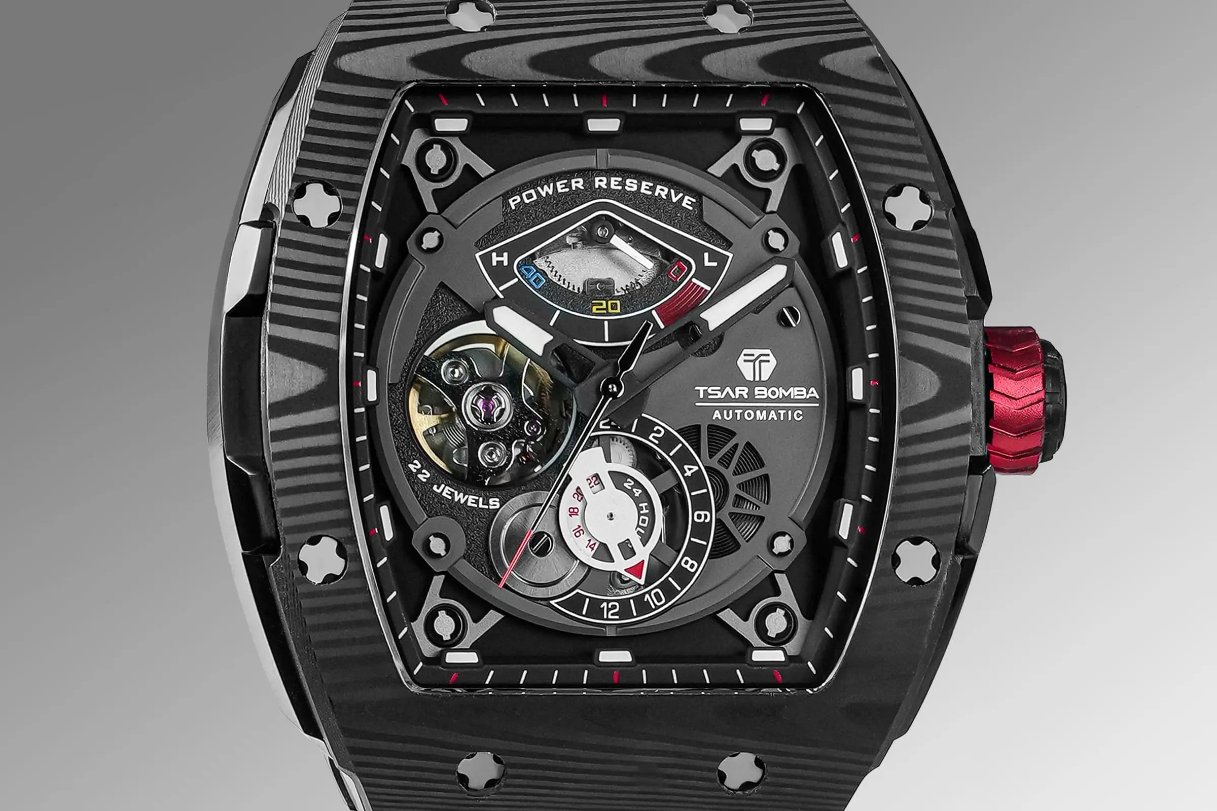 The TSAR BOMBA elemental TB8210CF automatic tourbillon tonneau-shaped watch features a carbon fiber bezel and a stainless steel case, powered by a Seiko Epson automatic movement. The tonneau-shaped case is paired with a skeletonized dial and a power reserve indicator.--dial-display、