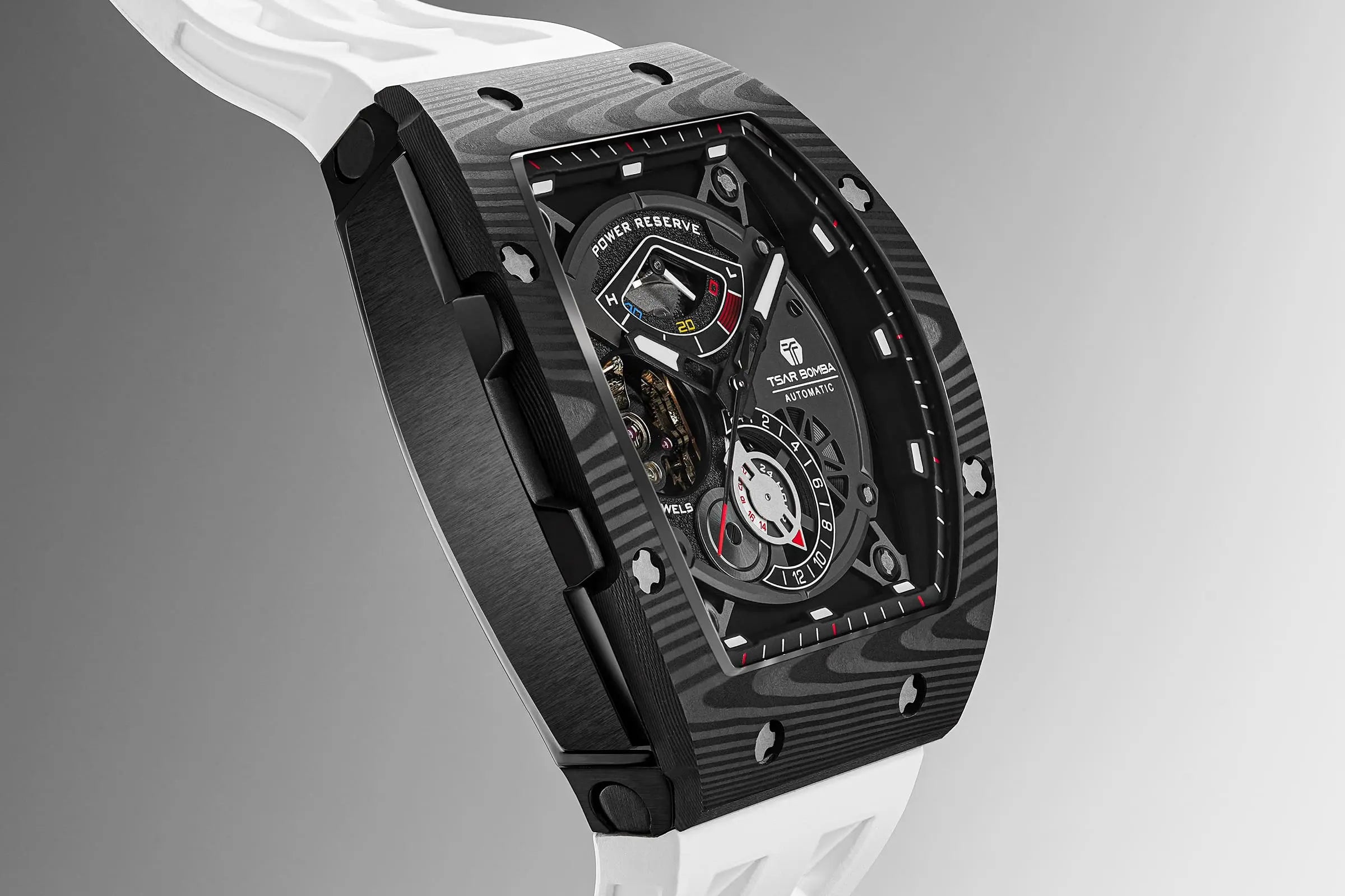 The TSAR BOMBA elemental TB8210CF automatic tourbillon tonneau-shaped watch features a carbon fiber bezel and a stainless steel case, powered by a Seiko Epson automatic movement. The tonneau-shaped case is paired with a skeletonized dial and a power reserve indicator.--Side view