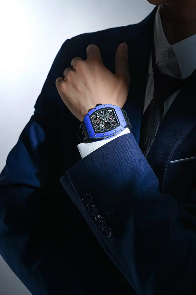 TSAR BOMBA Elemental TB8212 Skeletonized Automatic Mechanical Watch. Powered by a Seiko Epson automatic movement, featuring a lightweight and skin-friendly all-ceramic case. Equipped with Grade A luminous coating, scratch-resistant sapphire crystal, and a fluoroelastomer strap. Water resistant to 50 meters (5 ATM). Blue case and --Model wearing display.