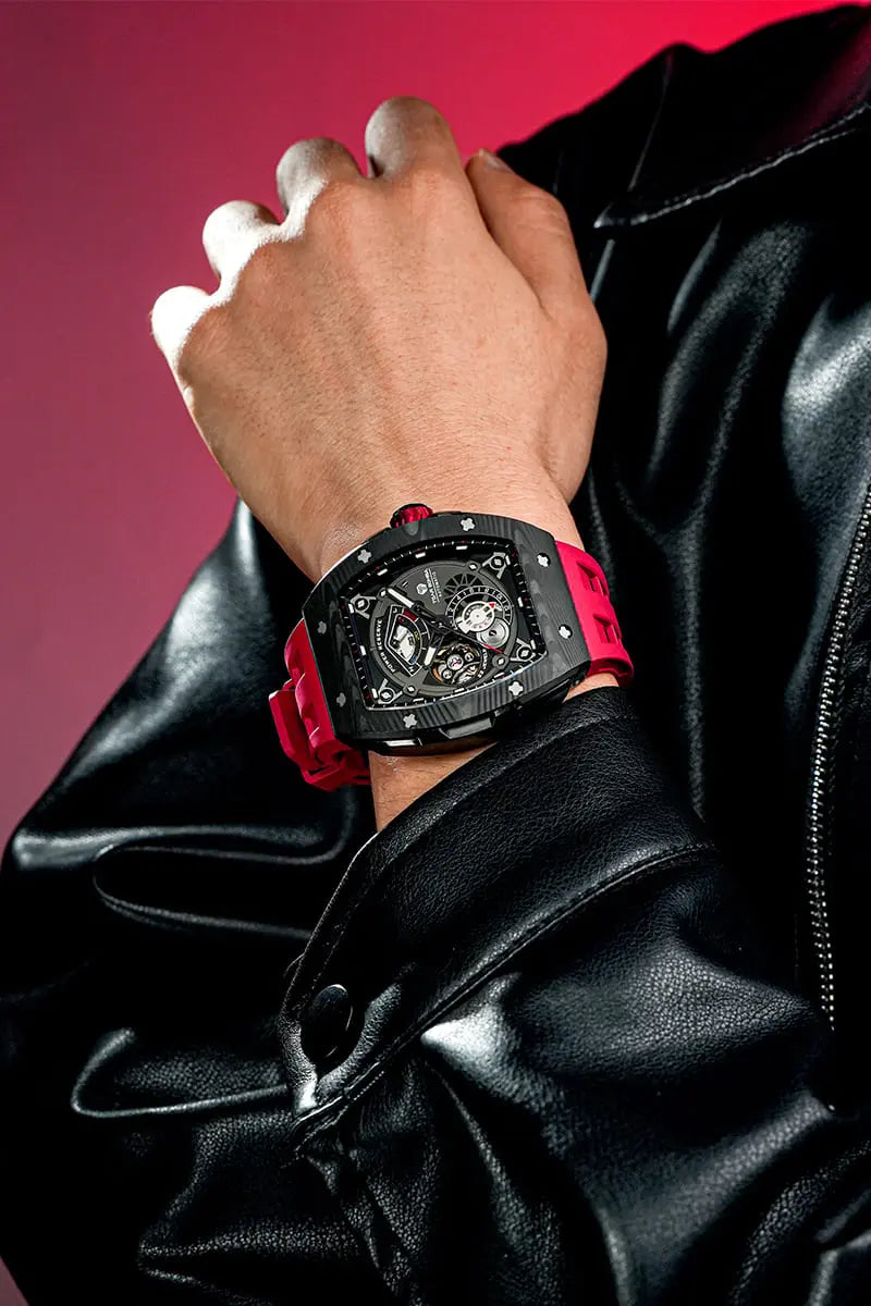 The TSAR BOMBA elemental TB8210CF automatic tourbillon tonneau-shaped watch features a carbon fiber bezel and a stainless steel case, powered by a Seiko Epson automatic movement. The tonneau-shaped case is complemented by a skeletonized dial and power reserve indicator. --Model wearing display