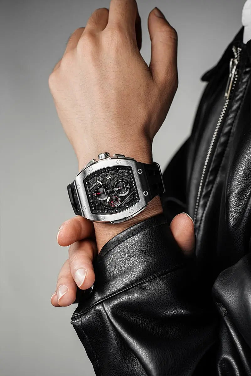 TSAR BOMBA Elemental TB8211Q Stainless Steel Tonneau Chronograph Watch. Features a stainless steel case and a precision-machined quartz movement. The textured dial integrates date display and chronograph function. A 1/20th-second counter is located at 12 o'clock, the date display at 3 o'clock, the hour/minute counter at 6 o'clock, and the seconds counter at 9 o'clock.--Model wearing display