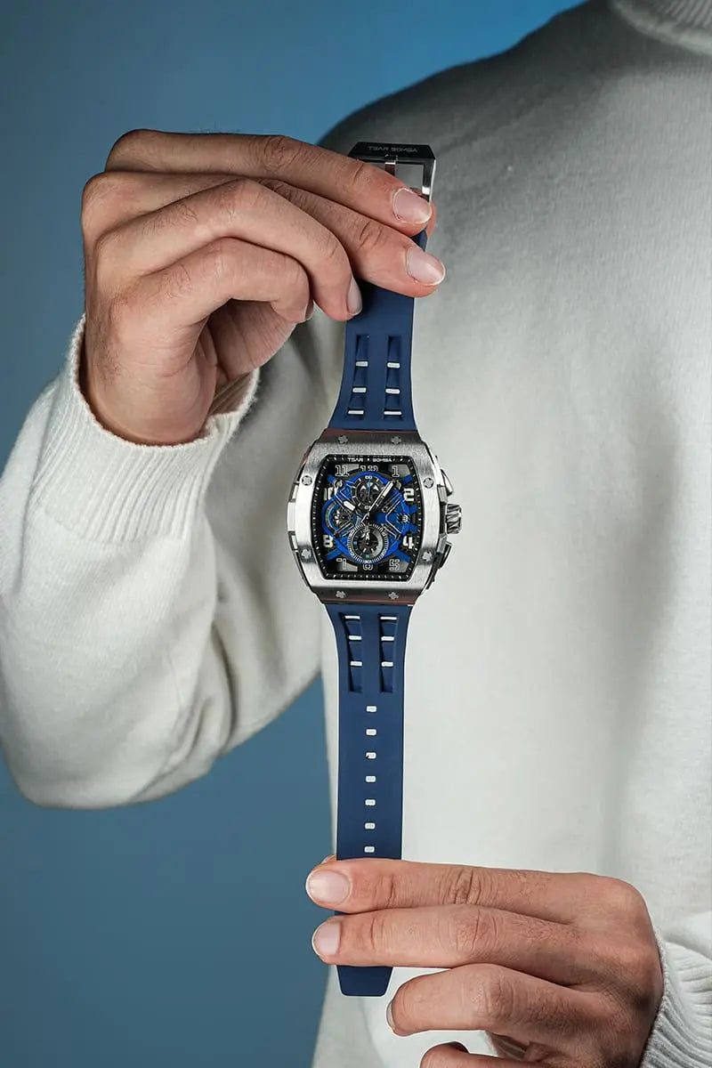 The TSAR BOMBA Elemental TB8211Q Stainless Steel Tonneau Chronograph Watch. Features a stainless steel case and a Seiko quartz movement. The multi-layered skeleton dial combines date display and chronograph functions. A 1/20th-second chronograph subdial is located at 12 o'clock, the date display at 3 o'clock, the hour/minute chronograph subdial at 6 o'clock, and the chronograph seconds subdial at 9 o'clock.-- Front panoramic view