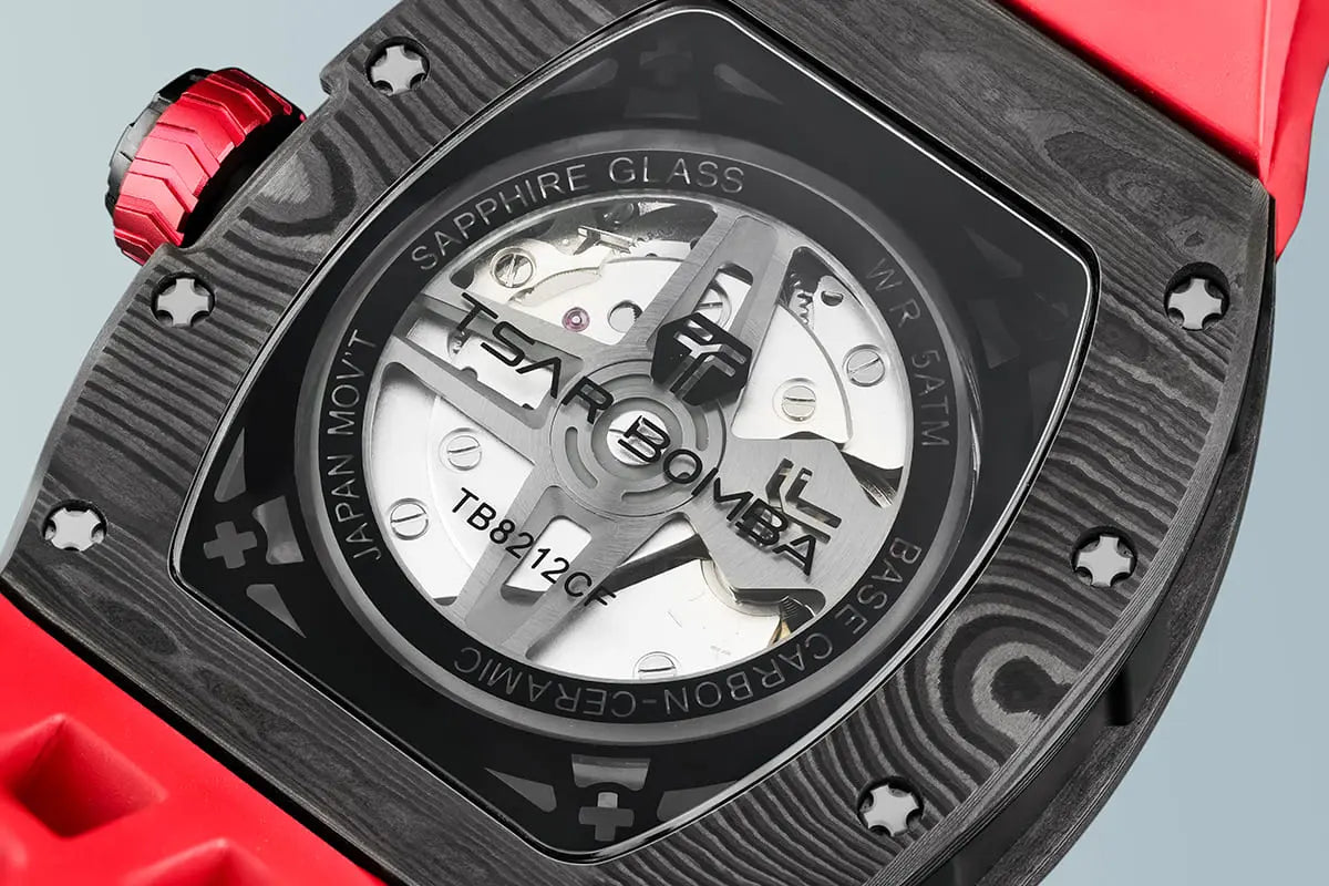 TSAR BOMBA Elemental TB8212 Skeletonized Automatic Mechanical Watch. Powered by a Seiko Epson automatic movement, featuring a lightweight and skin-friendly all-ceramic case. Equipped with Grade A luminous coating, scratch-resistant sapphire crystal, and a fluoroelastomer strap. Water resistant to 50 meters (5 ATM).---carbom fiber case--rear view