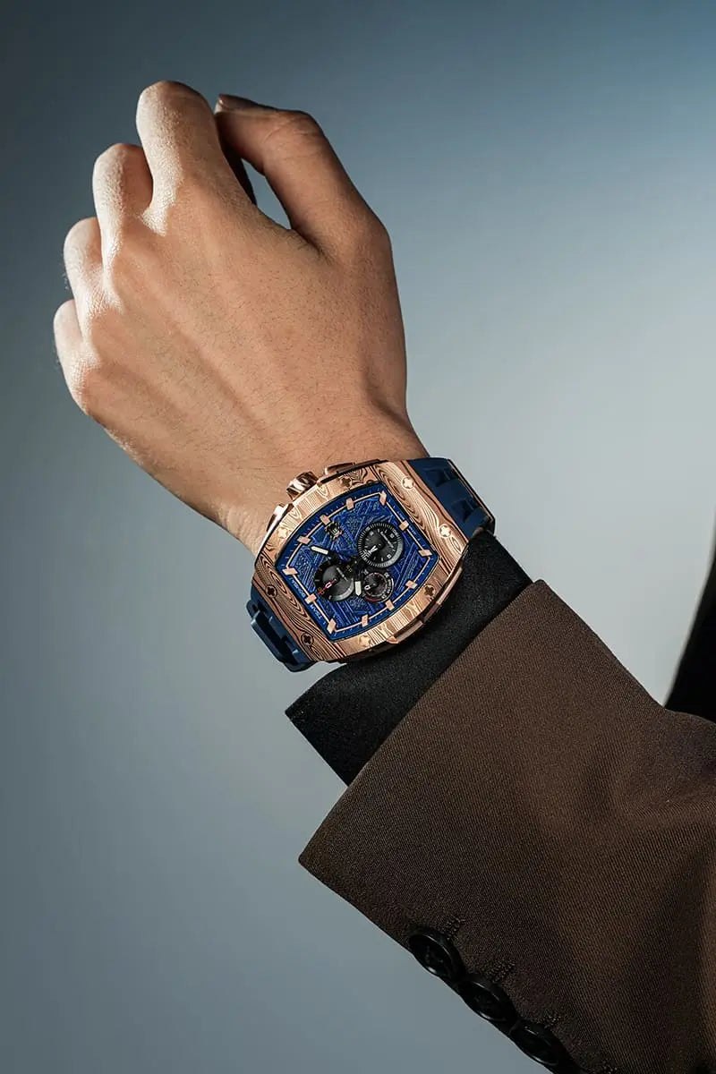  TSAR BOMBA Elemental TB8211Q Stainless Steel Tonneau Chronograph Watch. Features a stainless steel case and a precision-machined quartz movement. The textured dial integrates date display and chronograph function. A 1/20th-second counter is located at 12 o'clock, the date display at 3 o'clock, the hour/minute counter at 6 o'clock, and the seconds counter at 9 o'clock.--Model wearing display