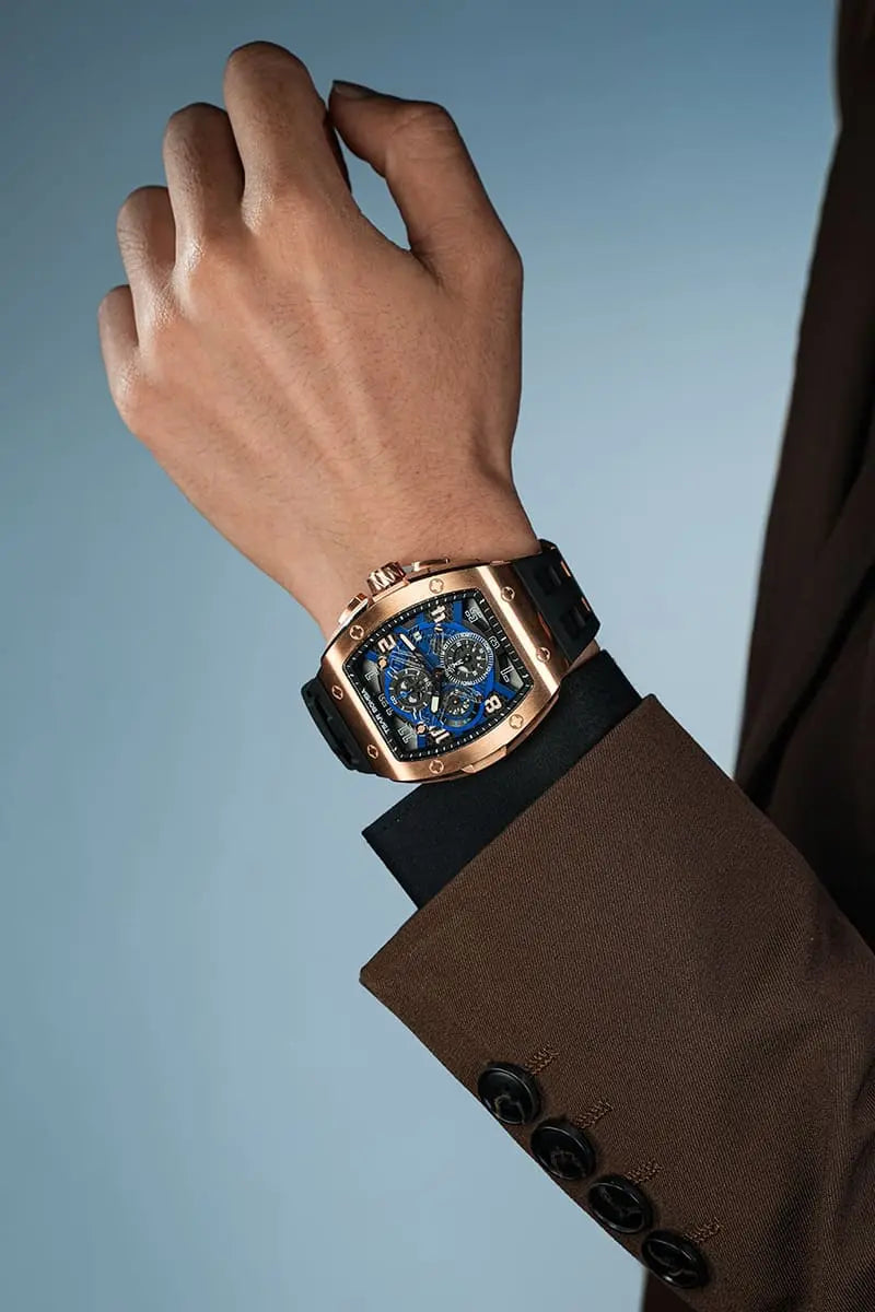 The TSAR BOMBA Elemental TB8211Q Stainless Steel Tonneau Chronograph Watch. Features a stainless steel case and a Seiko quartz movement. The multi-layered skeleton dial combines date display and chronograph functions. A 1/20th-second chronograph subdial is located at 12 o'clock, the date display at 3 o'clock, the hour/minute chronograph subdial at 6 o'clock, and the chronograph seconds subdial at 9 o'clock.--Model wearing display