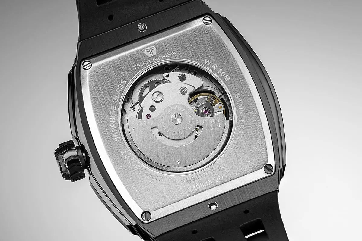 The TSAR BOMBA elemental TB8210CF automatic tourbillon tonneau-shaped watch features a carbon fiber bezel and a stainless steel case, powered by a Seiko Epson automatic movement. The tonneau-shaped case is complemented by a skeletonized dial and power reserve indicator. --Rear view