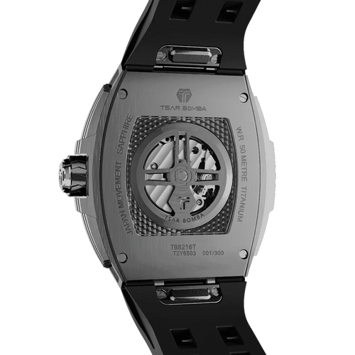 TSAR BOMBA TB8216 limited-edition tonneau watch, viewed from the rear, featuring a carbon fiber bezel and titanium case and black interchangeable strap. The power reserve indicator is at 12 o’clock, and the tourbillon is at 9 o’clock.--