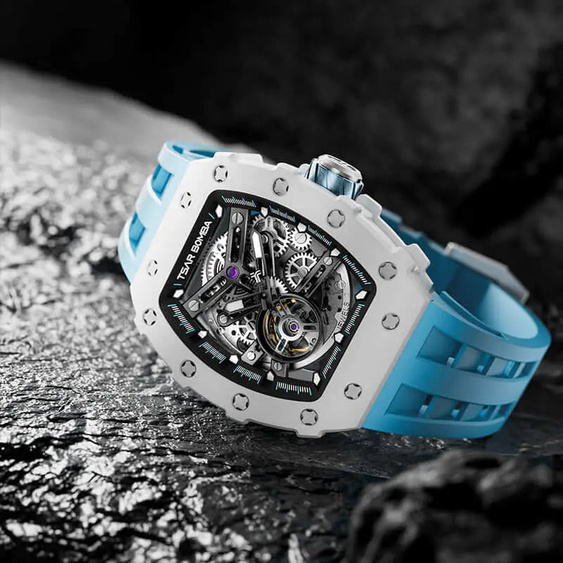 TSAR BOMBA TB8208C automatic skeleton tonneau men's watch, features a stainless steel case,  white ceramic bezel, and a blue strap.