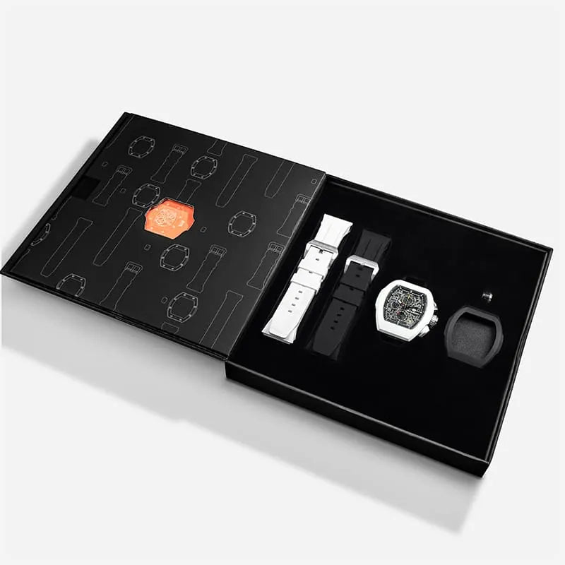 The image shows the TSAR BOMBA Atomic TB8214 interchangeable set. The set includes a black and white fluororubber strap, a black and white fluororubber bezel, and a white and black crown. TSAR BOMBA's patented interchangeable module allows for quick and easy replacement of watch modules without tools, enabling interchangeable straps, crowns, and bezels. Instead of buying multiple watches, why not own one watch that can be styled in various ways?--Set display and packaging box