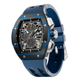 The TSAR BOMBA Atommic TB8214CF carbon fiber tonneau quartz watch. carbon fiber blue bezel and fluororubber interchangeable blue strap.  The Multifunction dial design, the multifunction dial features a chronograph minute sub-dial at the 12 o'clock position, a date display between the 4 and 5 o'clock positions, a seconds sub-dial at the 6 o'clock position, and an hour chronograph sub-dial at the 9 o'clock position. --Left three-quarter-view

