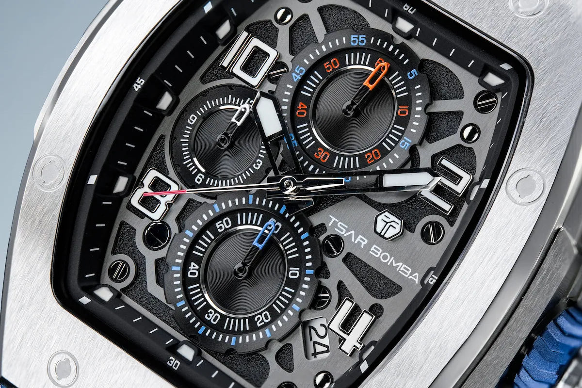 Silver bezel's TB8224Q dial display, The Multifunction dial design, the multifunction dial features a chronograph minute sub-dial at the 12 o'clock position, a date display between the 4 and 5 o'clock positions, a seconds sub-dial at the 6 o'clock position, and an hour chronograph sub-dial at the 9 o'clock position.