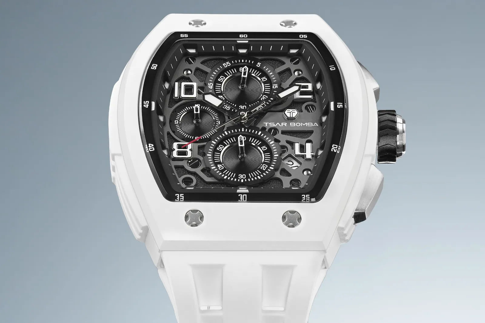 The TSAR BOMBA Elemental TB8224B BIO-ceramic tonneau quartz watch.White bezel and white strap.  The Multifunction dial design, the multifunction dial features a chronograph minute sub-dial at the 12 o'clock position, a date display between the 4 and 5 o'clock positions, a seconds sub-dial at the 6 o'clock position, and an hour chronograph sub-dial at the 9 o'clock position. --Top-down-view Blue-and-white gradient background