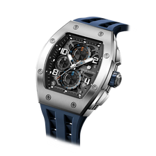 The TSAR BOMBA Elemental TB8224Q stainless steel tonneau quartz watch.silver bezel and blue strap.  The Multifunction dial design, the multifunction dial features a chronograph minute sub-dial at the 12 o'clock position, a date display between the 4 and 5 o'clock positions, a seconds sub-dial at the 6 o'clock position, and an hour chronograph sub-dial at the 9 o'clock position. --Left three-quarter angled view