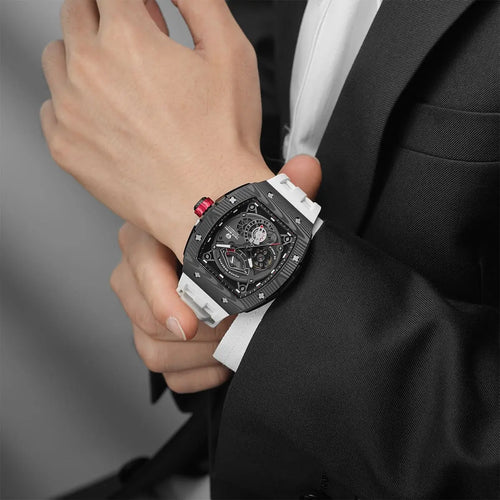 The TSAR BOMBA elemental TB8210CF automatic tourbillon tonneau-shaped watch features a carbon fiber bezel and a stainless steel case, powered by a Seiko Epson automatic movement. The tonneau-shaped case is paired with a skeletonized dial and a power reserve indicator.--Model wearing display