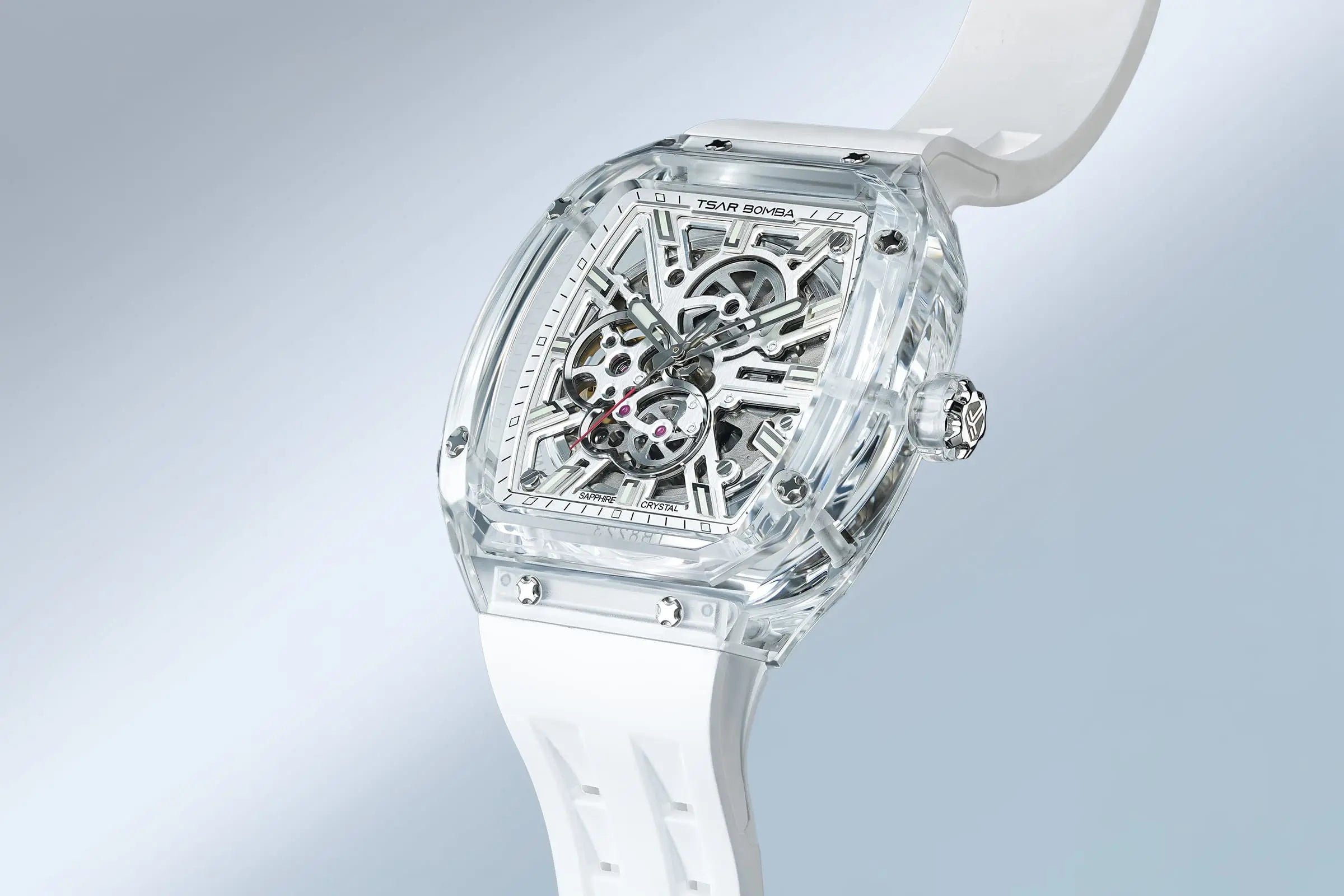 TSAR BOMBA Light Matter TB8223 Transparent Men's Watch. This watch features a TSAR BOMBA Chronite® case, allowing for quick and easy strap changes without tools. It is powered by a Japanese automatic movement with a flying tourbillon at 9 o'clock. The TB8223 includes a Grade A luminous coating, a scratch-resistant sapphire crystal, and a replaceable fluoroelastomer strap. It is water-resistant to 30 meters (3 ATM). white strap--Scene display
