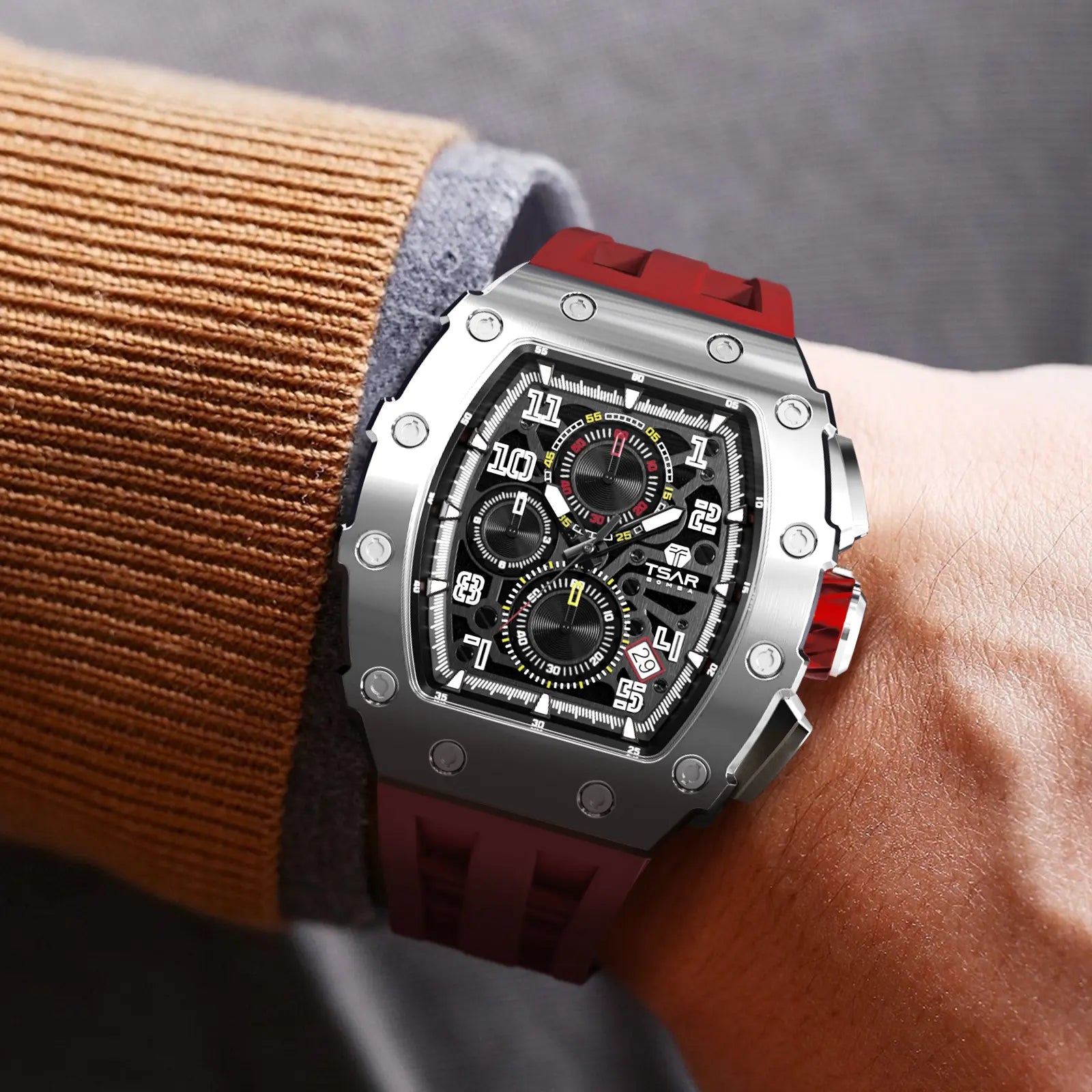 The TB8204Q is a photo showing the tsarbomba elemenetal watch as worn on the wrist. The TB8204Q features a Seiko quartz movement with chronograph and calendar functions. It has a 316L stainless steel bezel and case, along with a silicone strap. It is a stylish watch perfect for fashion-conscious individuals. The image shows the model with a silver case and red strap.