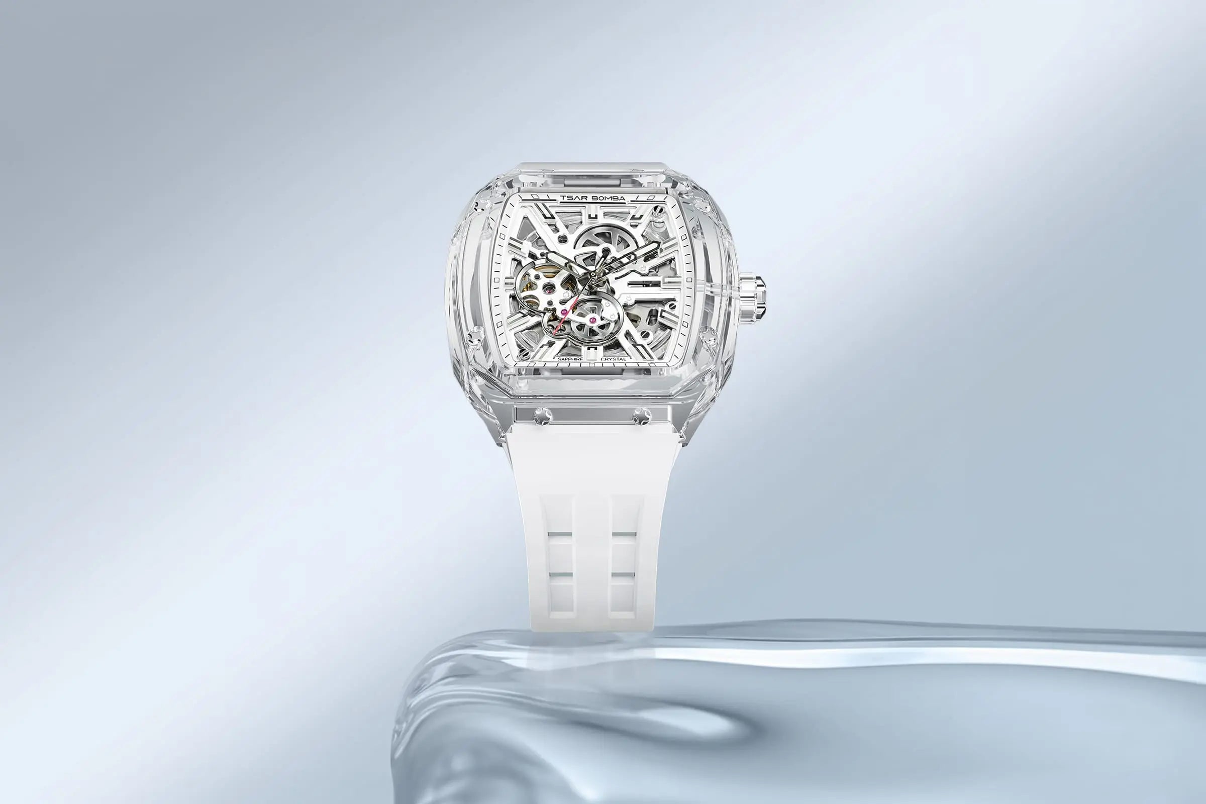 TSAR BOMBA Light Matter TB8223 Transparent Men's Watch. This watch features a TSAR BOMBA Chronite® case, allowing for quick and easy strap changes without tools. It is powered by a Japanese automatic movement with a flying tourbillon at 9 o'clock. The TB8223 includes a Grade A luminous coating, a scratch-resistant sapphire crystal, and a replaceable fluoroelastomer strap. It is water-resistant to 30 meters (3 ATM). --Scene display